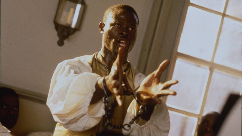 Amistad screenplay hero image includes a man in a courtroom, circa 1837, his hands bound with chains.