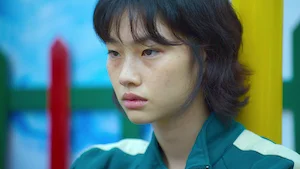 Still image from season 1, episode 3, of the Netflix series Squid Game, representing the transcript 'The Man with the Umbrella'.